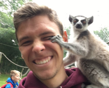 A photo of me with a Ring-tailed Lemur on my shoulder.